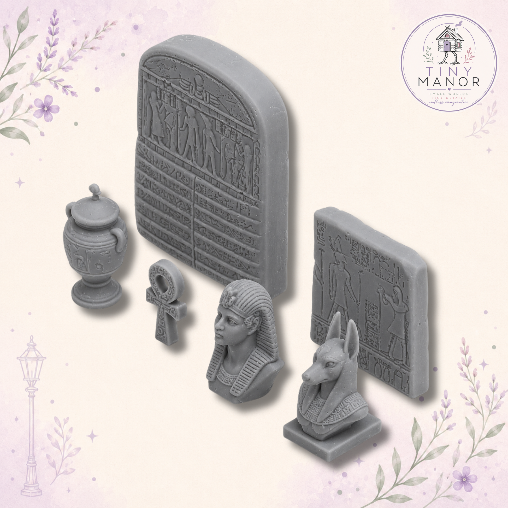 Set of six unpainted grey resin Ancient Egyptian miniatures including Anubis, pharaoh, urn, ankh and carved tablets.